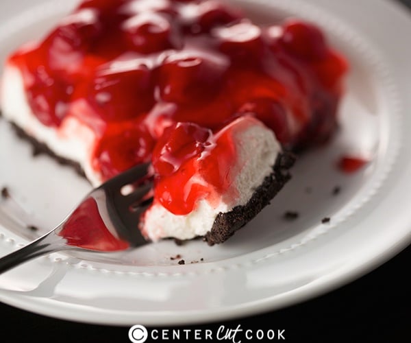 cheesecake with Oreo crust topped with cherry pie filling