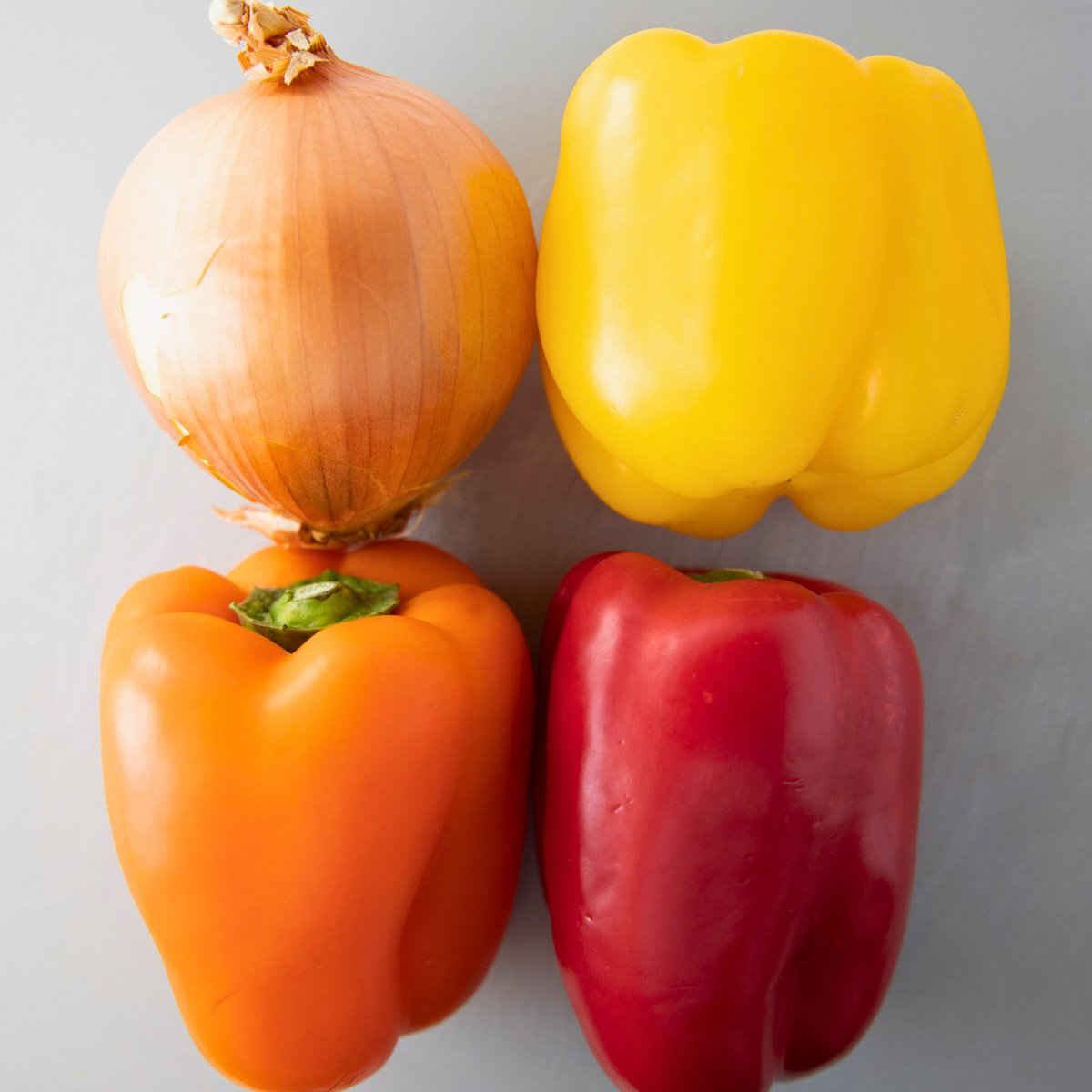 overhead of bell peppers and an onion for fajita veggies