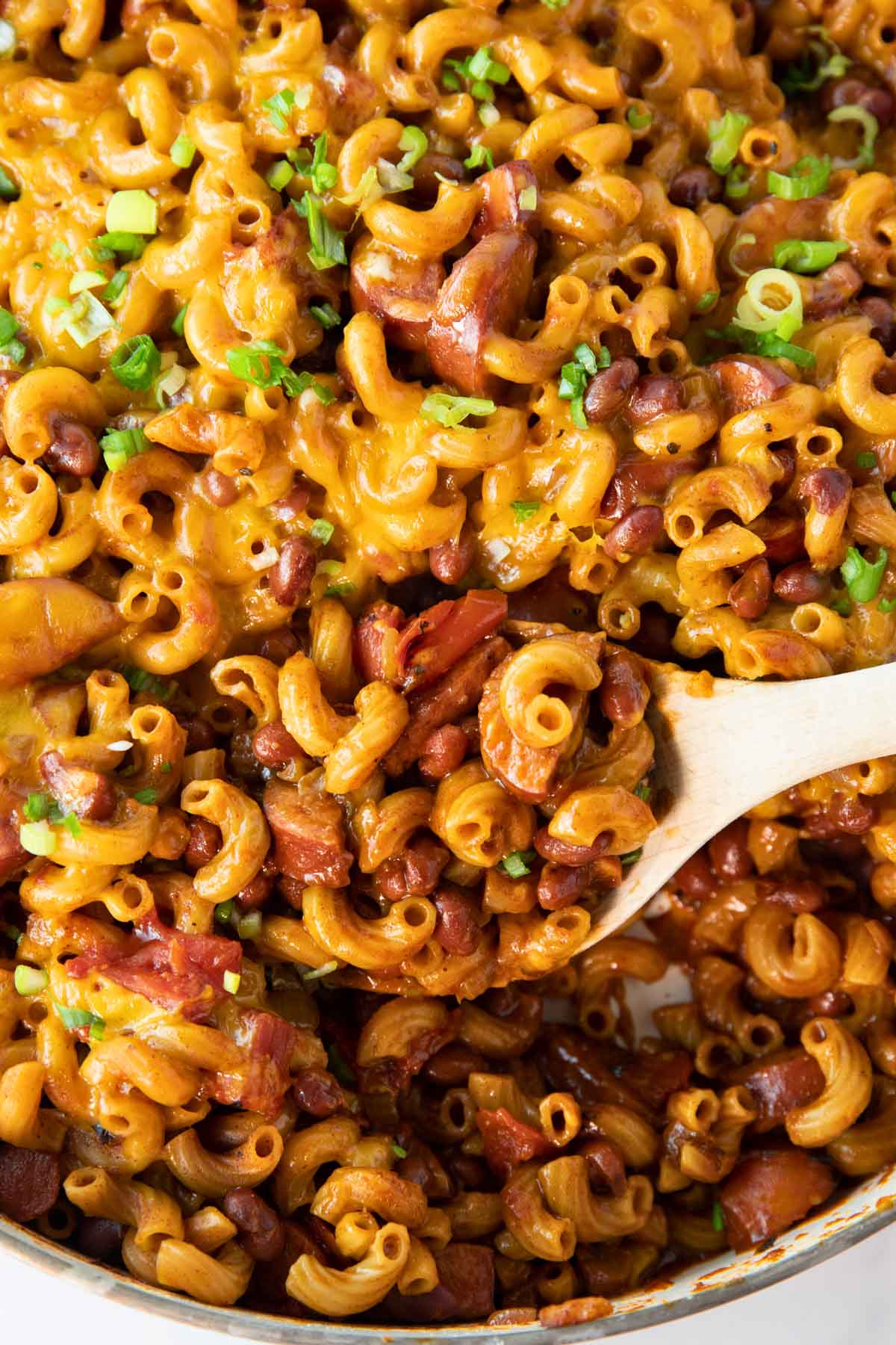 pan of chili mac with a spoon for serving